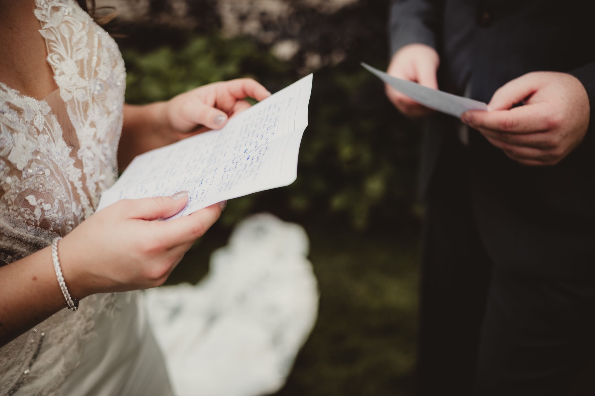 Bride and groom reading wedding vows to each other